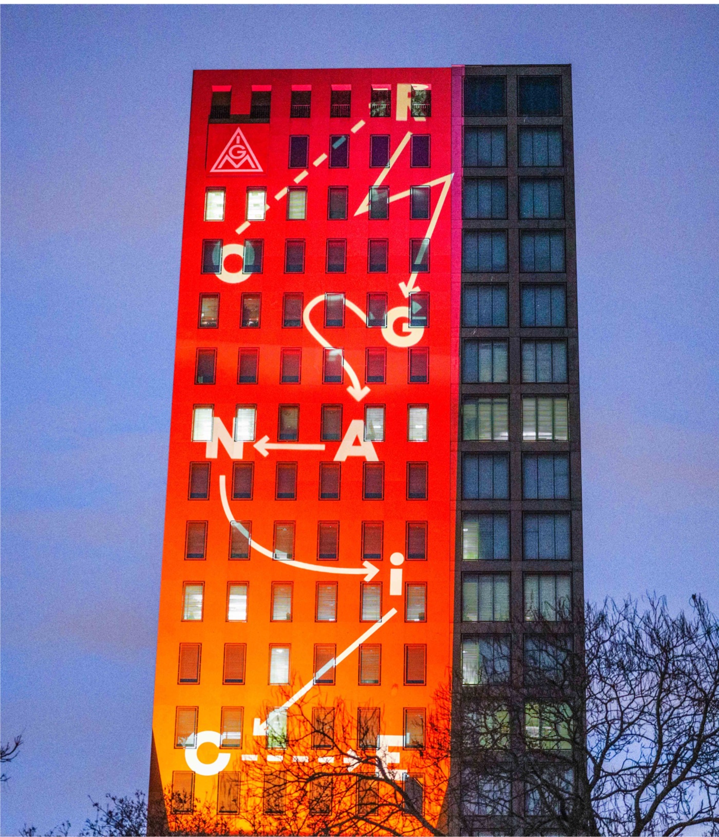Organice letters and arrows projected onto a tower
